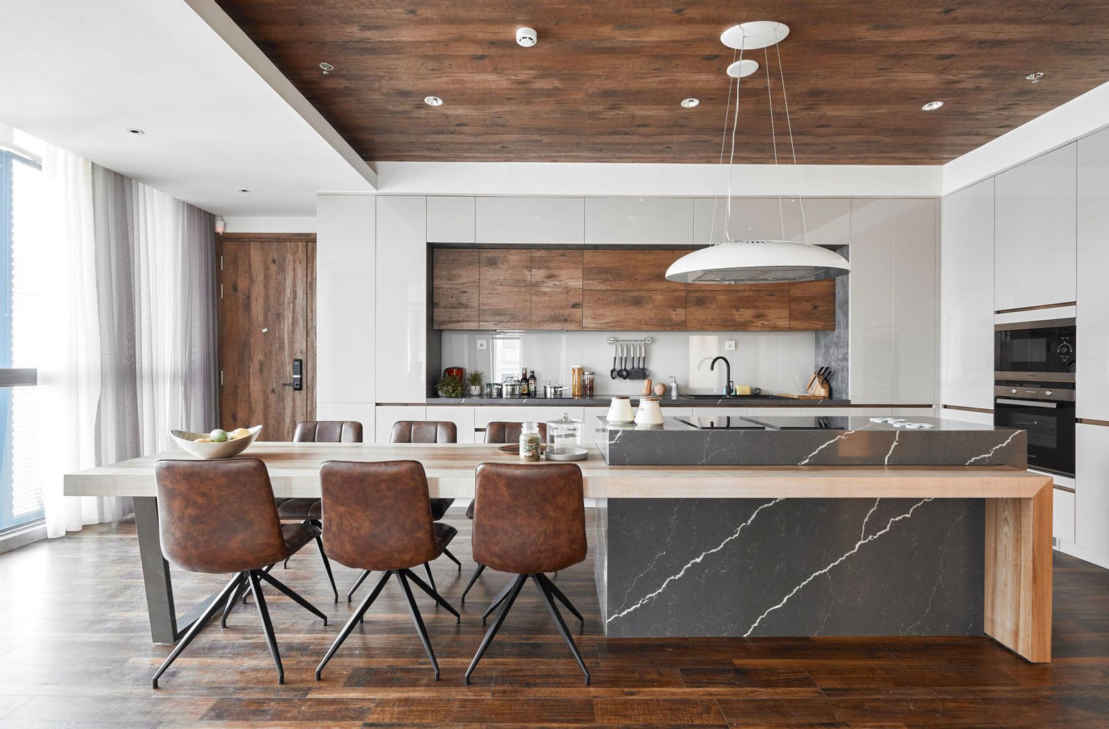 Mid-century modern kitchen featuring sleek cabinetry and vibrant countertops from Zen Living, Calgarys home renovation exp...