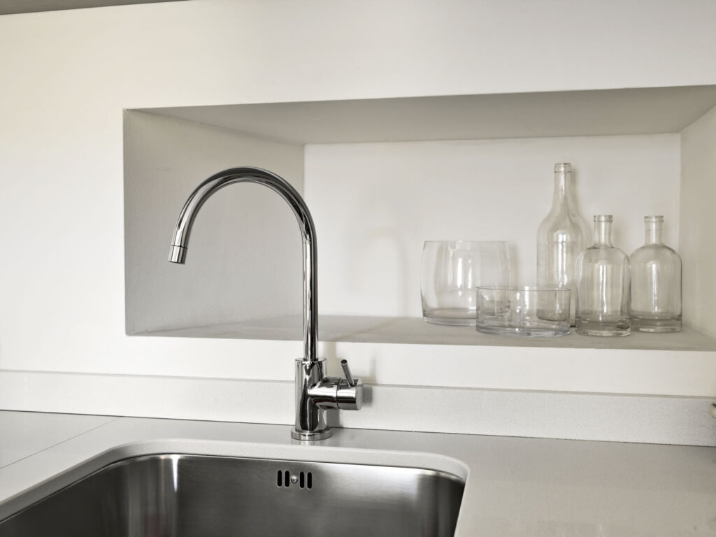 Modern kitchen sink with glassware.